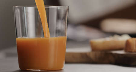 pour pumpkin juice into tumbler glass with copy spaceの写真素材