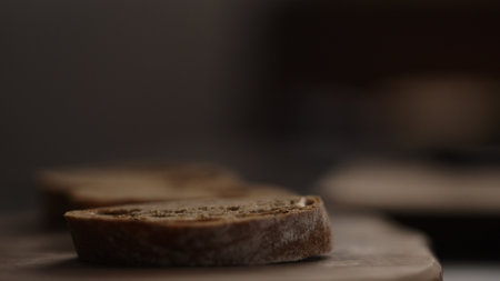 slices of dark ciabatta on wood boardの写真素材