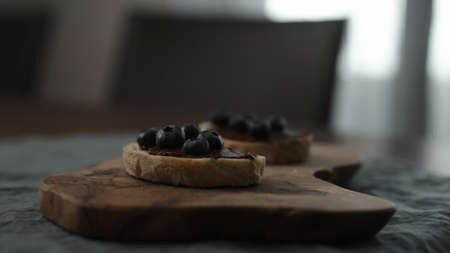 blueberries on chocolate spread on ciabatta slice on dining tableの写真素材