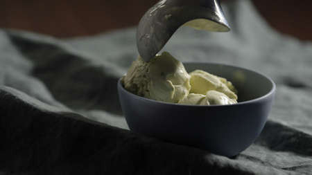 put a ball of pistachio ice cream into small blue bowl