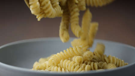 pesto fusilli poured in blue bowlの写真素材