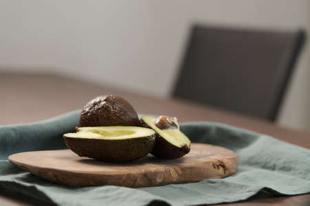 Ripe avocados on olive wood board