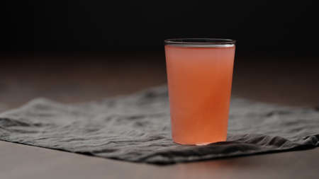 guava drink from can into tumbler glass on table