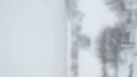 vertical bokeh background of snowfall with shallow depth of fieldの写真素材