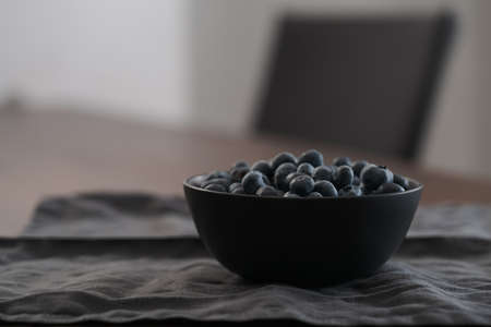 big bowl with blueberries on tableの写真素材