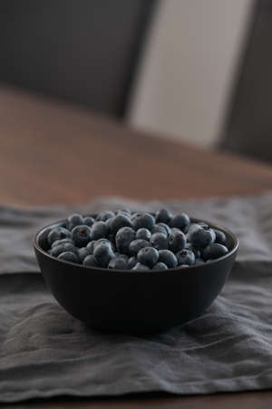 big bowl with blueberries on tableの写真素材