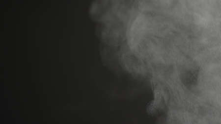 Steam rising over black backgroundの写真素材