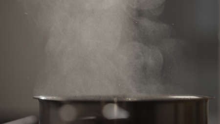 closeup water boiling in saucepan on induction stoveの写真素材