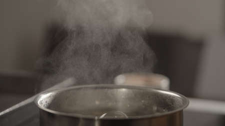 closeup water boiling in saucepan on induction stove