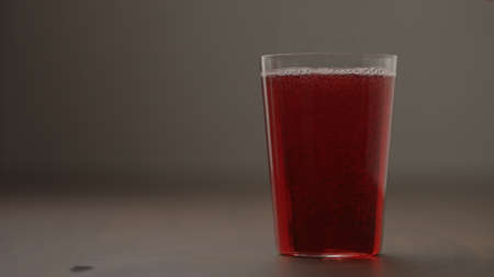 berry soft drink in tumbler glass on wood table with copy spaceの写真素材
