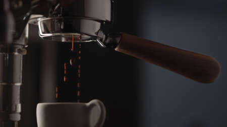 pull espresso shot with bottomless portafilter on a professional coffee machineの写真素材