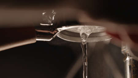rinsing coffee machine with bottomless portafilter closeup