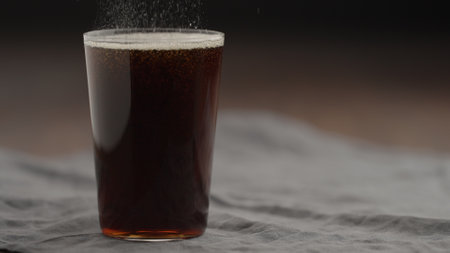 cola in tumbler glass on linen cloth with copy spaceの写真素材