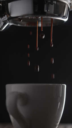 shot pull espresso shot with bottomless portafilter on a professional coffee machineの写真素材