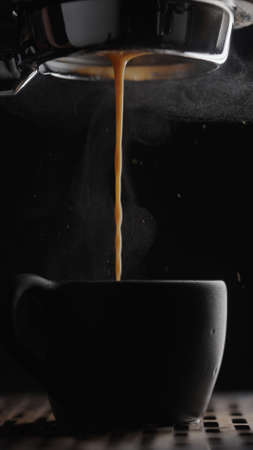 shot pull espresso shot with bottomless portafilter on a professional coffee machineの写真素材