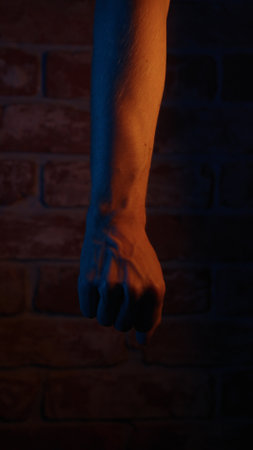 vertical closeup shot of man hand under neon lightの写真素材