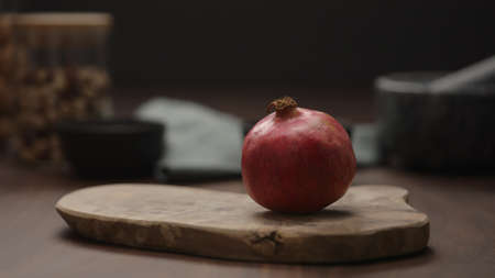 small pomegranate on wood boardの写真素材