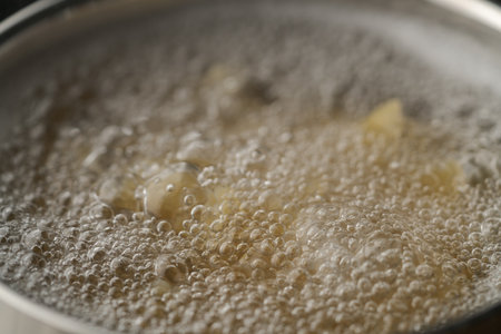 Farfalle pasta in hot boiling water in saucepan closeupの写真素材