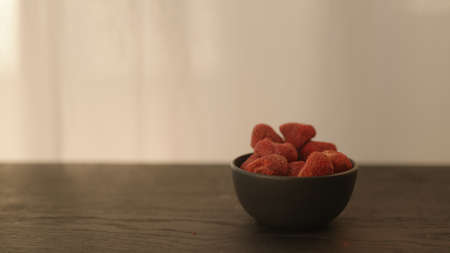 freeze dried strawberries in black bowl with copy space