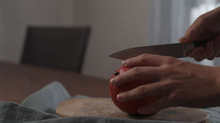 Man cutting fresh mango on wood board