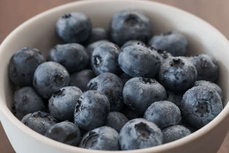 Fresh washed blueberries in white bowl closeupの写真素材