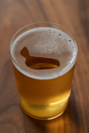 Organic apple cider in tumbler glass on wood table