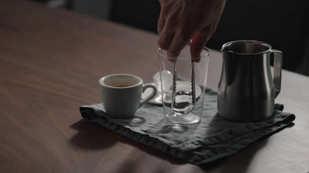 making espresso tonic in tumbler glass on walnut tableの写真素材