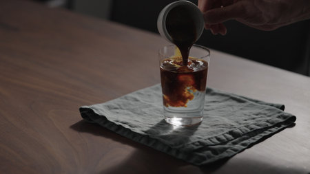 making espresso tonic in tumbler glass on walnut tableの写真素材