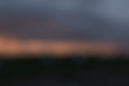 Blurred background of dramatic sky with orange sunsetの写真素材
