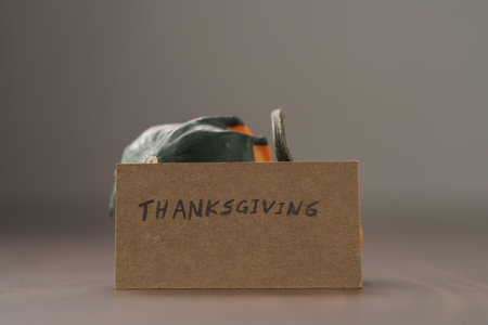 Decorative small pumpkin on wood table with thanksgiving greeting cardの写真素材