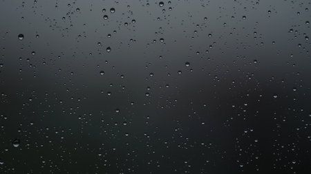 Real background of rain hitting glass with protective coatingの写真素材