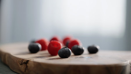 Fresh berries on wood olive board on linen napkinの写真素材