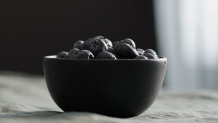 Fresh blueberries in bowl on linen napkinの写真素材