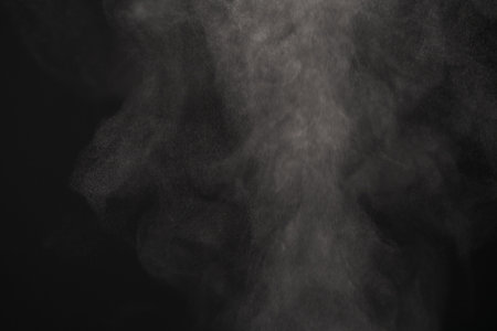 Closeup of water steam over black background