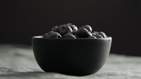 Fresh blueberries in bowl on linen napkinの写真素材