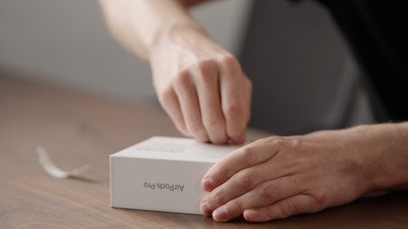 Saint-Petersburg, Russia -Circa december 2022: Man unboxing new apple airpods pro 2nd generation...
