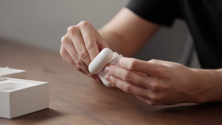 Saint-Petersburg, Russia -Circa december 2022: Man unboxing new apple airpods pro 2nd generation earbudsのeditorial素材