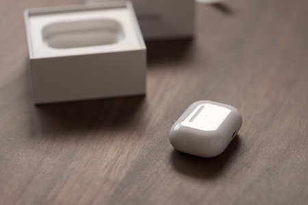 Saint-Petersburg, Russia - Circa December, 2022: Apple AirPods Pro 2nd generation unboxing photo on walnut tableのeditorial素材