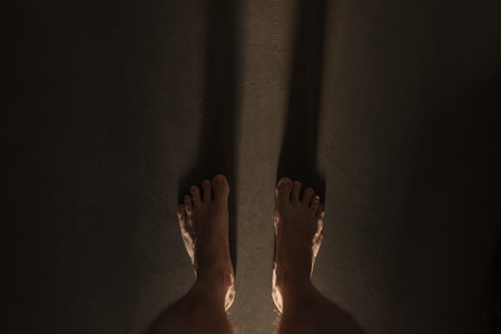 Man legs indoor shot with long shadow during sunriseの写真素材