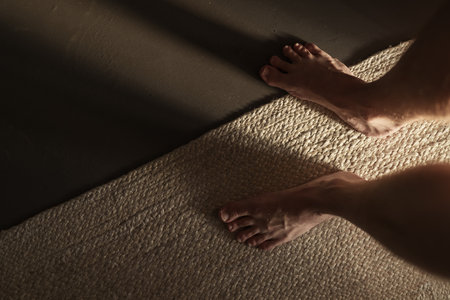 Man legs indoor shot with long shadow during sunrise