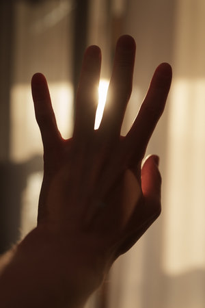 Abstract man hand playing with sunset light indoor