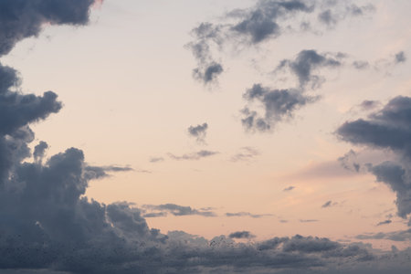 Evening clouds in the sky in summer evening with warm lightの写真素材