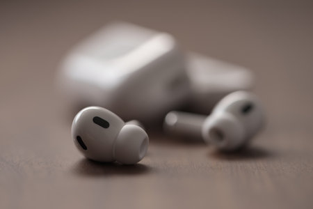 Saint-Petersburg, Russia - Circa December, 2022: Apple AirPods Pro 2nd generation on walnut table