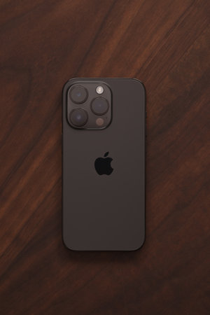 Saint-Petersburg, Russia - Circa December, 2022: closeup of iPhone 14 Pro Space Black on wood backgroundのeditorial素材