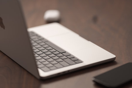 Saint-Petersburg, Russia - Circa December, 2022: open apple macbook pro 14 inch with iphone 14 pro space black on walnut tableのeditorial素材