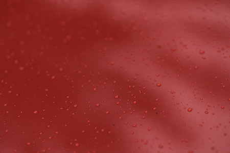 Raindrops on car paint surface after protection treatmentの写真素材