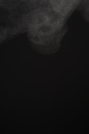 Closeup of water steam over black background