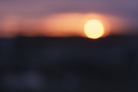Bokeh photo of sunset over city in winterの写真素材
