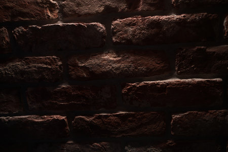 Old brisk wall with dramatic lightの写真素材
