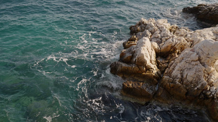 Azure waves of mediterranean sea splashing on French Riviera coastの写真素材